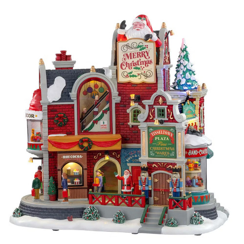 A festive holiday scene featuring a beautifully decorated Christmas shop with colourful signs, a snow-covered roof, and cheerful decorations.