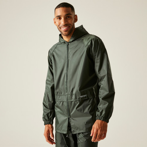 Smiling man wearing a dark green rain jacket stands against a neutral background. The jacket has a hood and zippered front, conveying a casual and comfortable vibe.