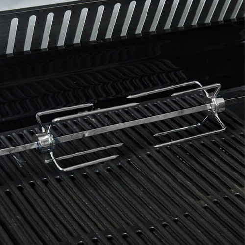 Rotisserie rod with forks resting on barbecue grill grates.