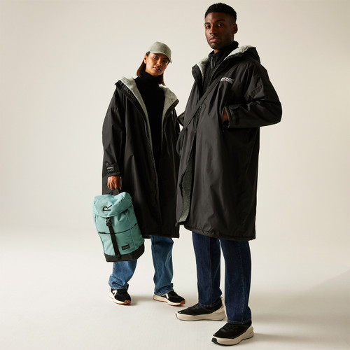 A woman and a man wearing a black waterproof changing robe.