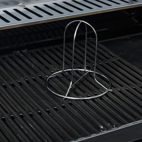 Stainless steel beer can chicken roaster standing on barbecue grill grates.