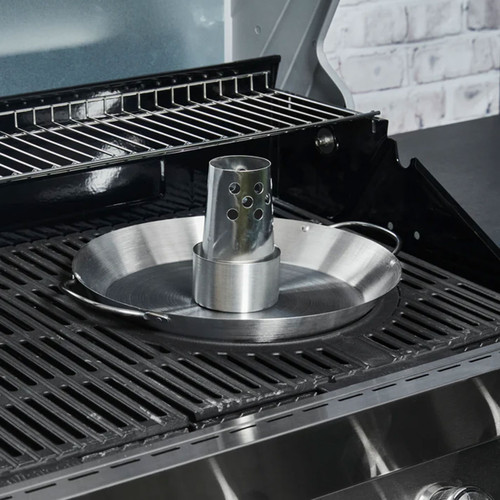 Stainless steel beer can chicken roaster in a barbecue grill