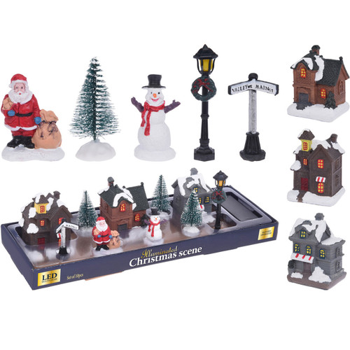 A village scene set including houses, snowmen, Santa, a tree, lamppost and street sign.