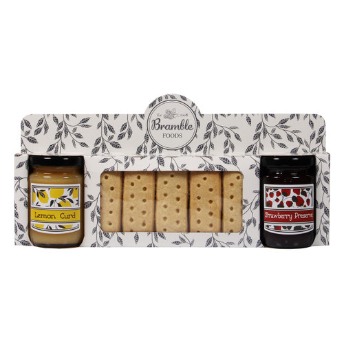 Gift set featuring a jar of lemon curd, shortbread cookies, and a jar of strawberry preserve. The packaging has a leaf pattern and a vintage feel.