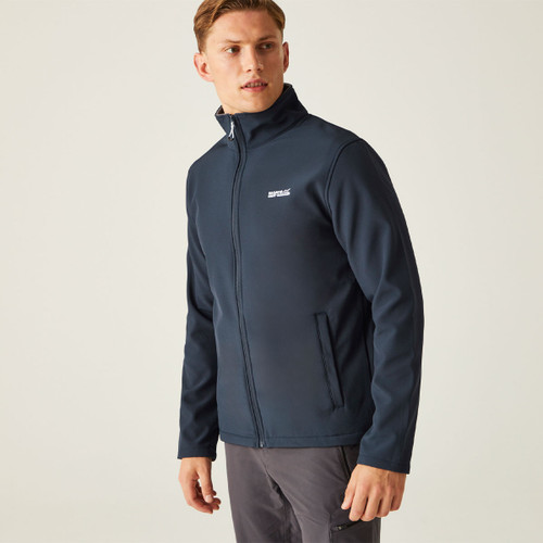 Young man wearing a navy jacket stands against a neutral background, looking to the side. The tone is casual and focused, highlighting the jacket's design. Young man wearing a navy jacket stands against a neutral background, looking to the side. The tone is casual and focused, highlighting the jacket's design.