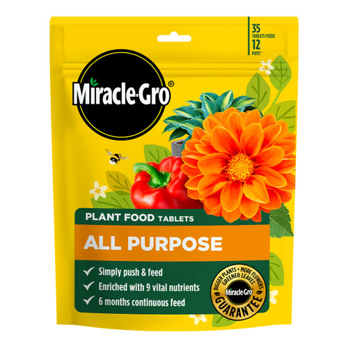 Yellow Miracle-Gro bag showing bright orange flowers and a red bell pepper. Text highlights its all-purpose plant food tablets, emphasizing easy use and nutrient enrichment.