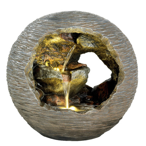 A spherical stone fountain with a hollow center features cascading water over golden rocks, creating a serene and natural ambiance.