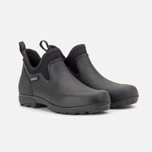 A pair of black, waterproof slip-on shoes with pull tabs on a light gray background. The shoes have a rugged sole for durability and outdoor use.