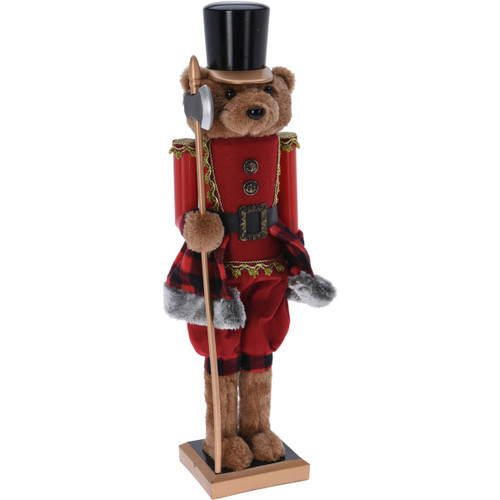 A bear nutcracker holding an axe and wearing a red uniform with a black hat.