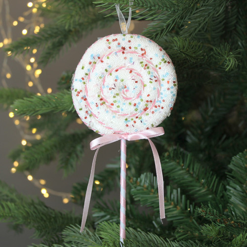 A view of a large pastel lollipop pick on a Christmas tree