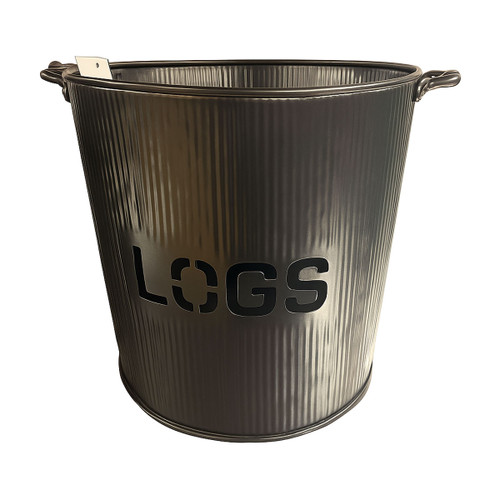 Metal log storage bucket with ribbed texture and side handles, featuring cut-out ‘LOGS’ text on the front, ideal for storing firewood beside a fireplace or stove.