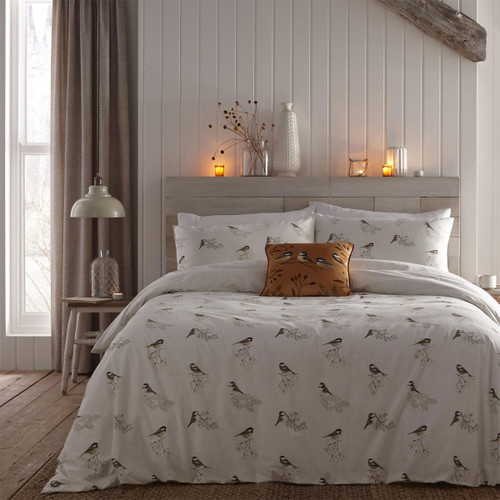 View of a natural Dreams & Drapes Lodge Chickadees Bedding Set on a bed