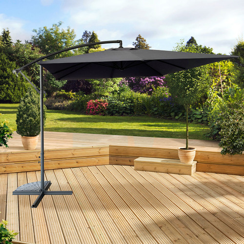 A view of a grey overhanging parasol on some decking in a garden