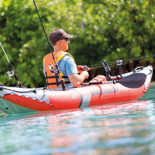 Man fishing from an Intex Excursion Pro K1 inflatable kayak on a lake