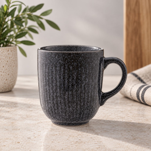 Charcoal grey reactive glaze mug styled on a kitchen worktop