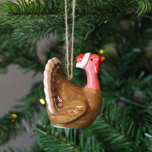 A view of a ceramic Christmas Turkey Hanging Decoration hanging on a Christmas tree