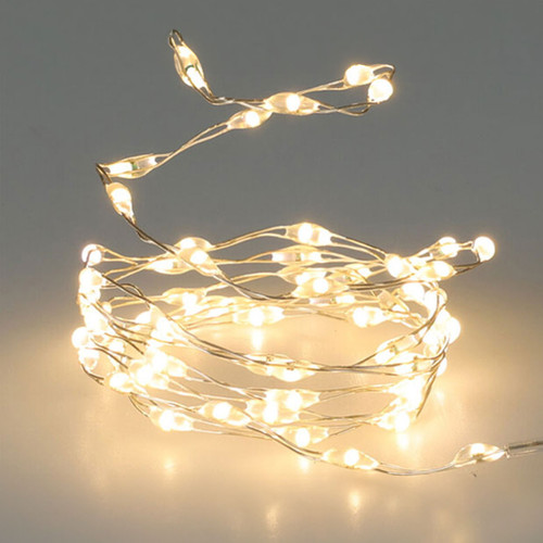Warm white LED micro string lights on flexible silver wire, providing soft ambient lighting for Christmas trees, table decorations and festive displays.
