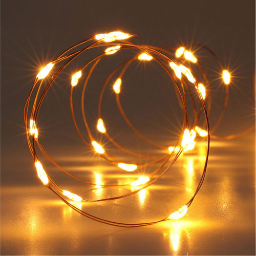 Warm white LED copper wire fairy lights with micro LEDs, creating a cosy ambient glow for Christmas decorations, table centrepieces, wreaths and festive displays.