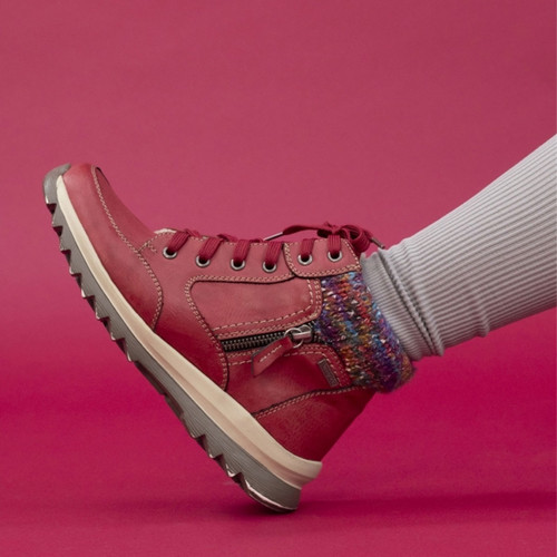 Side view of women's red ankle boot with multicolour knit collar, zip and lace closure, contrast stitching, and chunky ridged sole for grip.