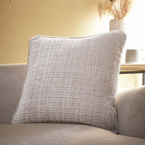 A natural coloured cushion on a sofa