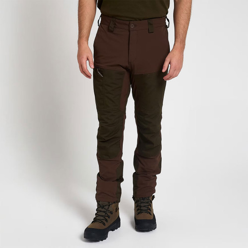 Man wearing two-tone brown and olive green outdoor trousers with reinforced panels and hiking boots, shown from the front.