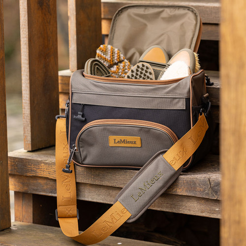 An alpine coloured grooming bag on a wooden step
