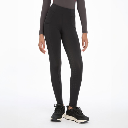 A person wearing a pair of black breechess