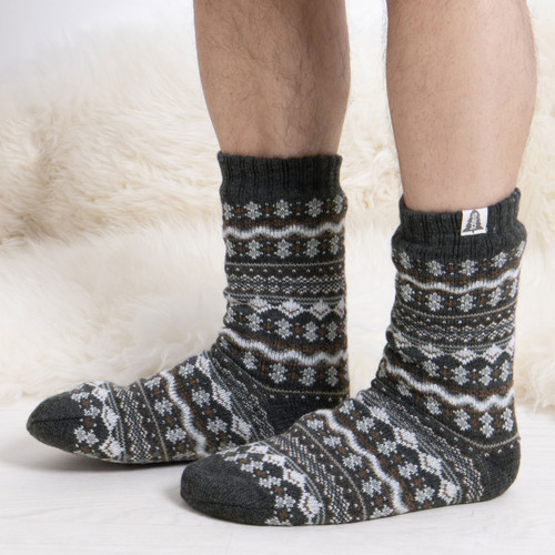Someone wearing a pair of grey fair isle slipper socks.