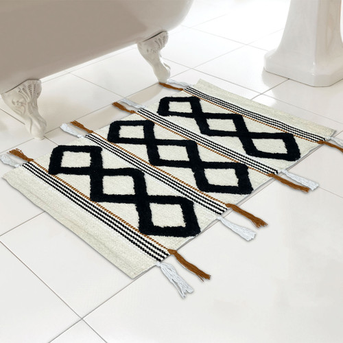 A natural bath mat with geometric tassel design