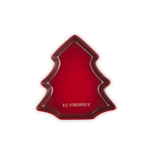 Red Le Creuset Christmas tree-shaped plate on a white background.
