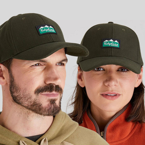 A man and a woman wearing an olive green Ridgeline cap with a curved brim and logo patch, paired with an orange fleece vest.