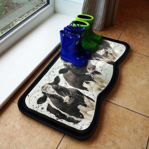 A pair of blue and green rain boots on a cow-patterned boot tray by a window, set on a tiled floor, creating a playful and cosy atmosphere.