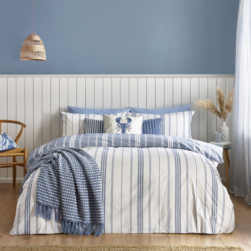 A view of a reversible white bedding set with blue stripes