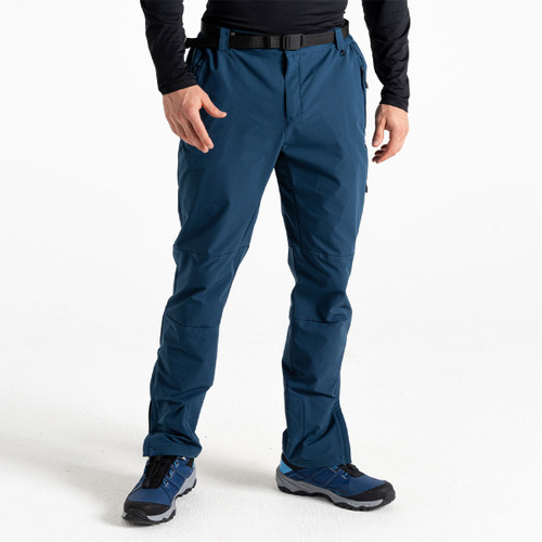 A man wearing a pair of blue walking trousers with blue walking boots.