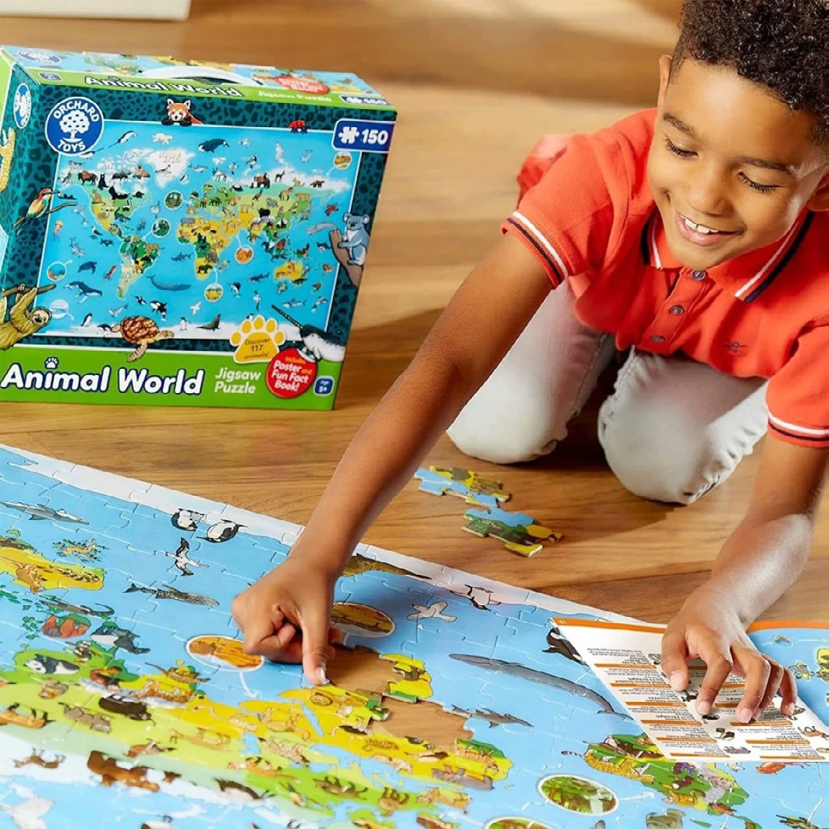 boy playing on the floor with a puzzle