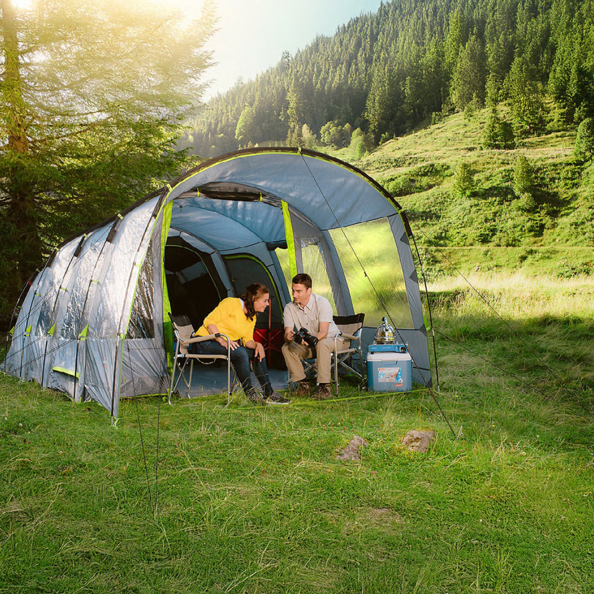 family tunnel tent pitched in a forest