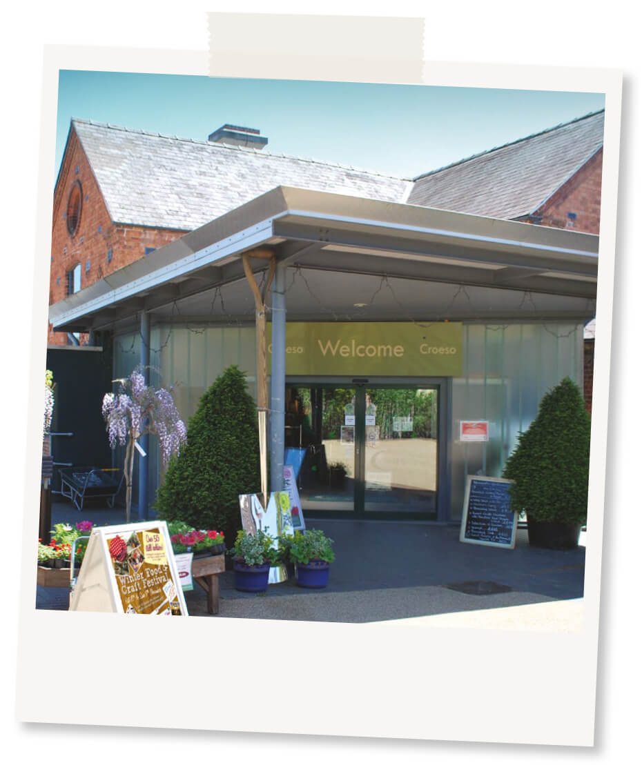 Polaroid design image of Coed-y-Dinas front entrance on a sunny day 