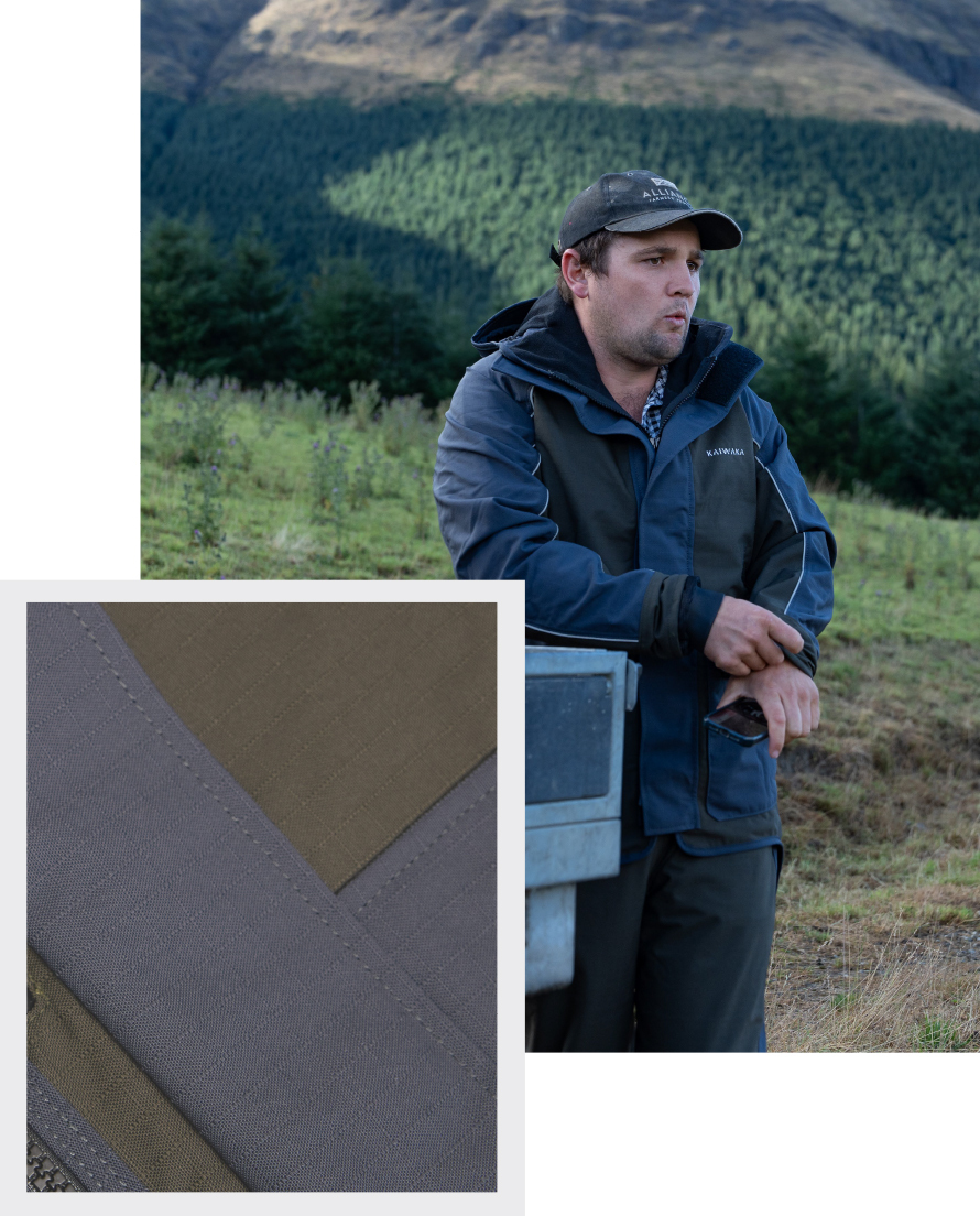 Man in outdoor gear leans on equipment in front of a lush forested hill. Inset shows close-up of the fabric texture, emphasizing ruggedness.