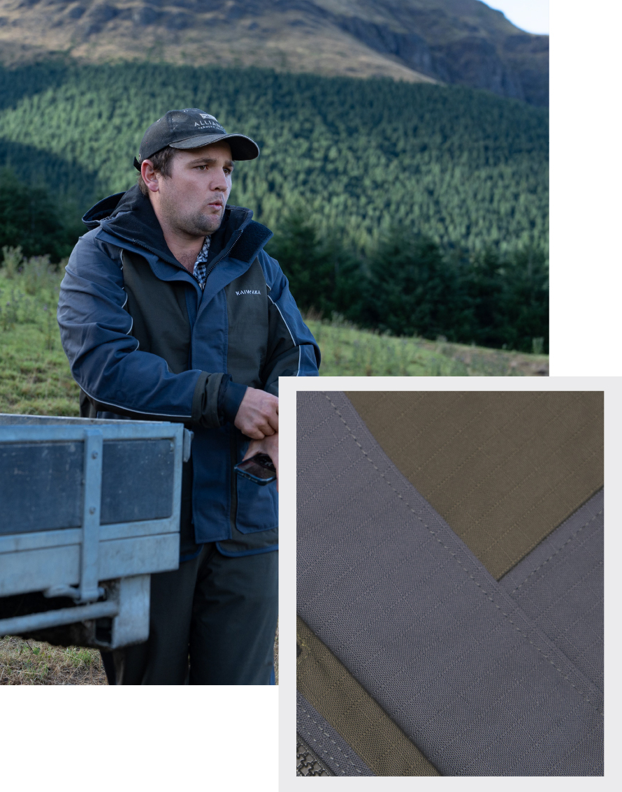 Man in outdoor gear leans on equipment in front of a lush forested hill. Inset shows close-up of the fabric texture, emphasizing ruggedness.