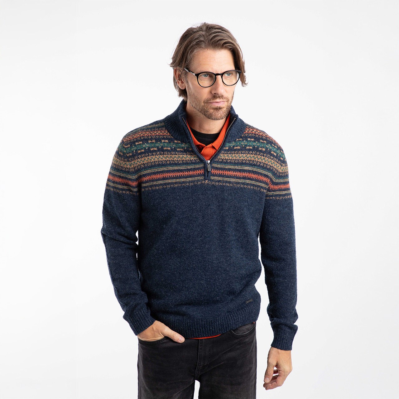 A man wearing a navy Weird Fish quarter zip fleece with a fair isle print.