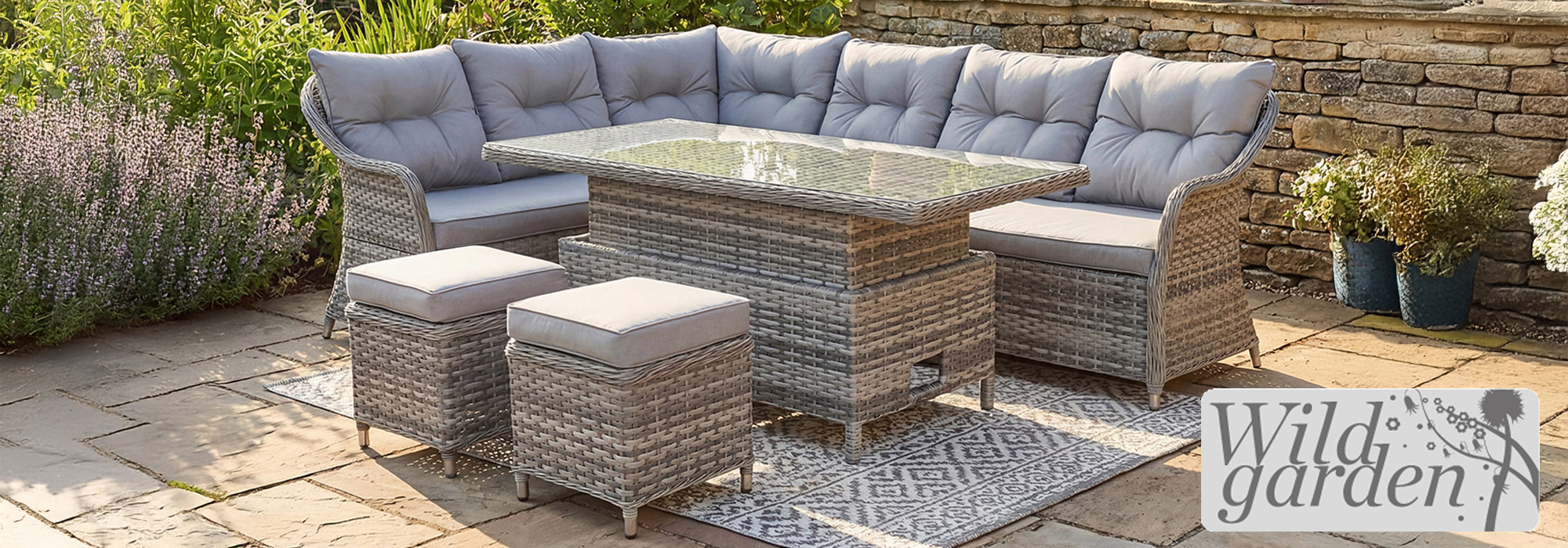 A view of a Wild Garden rattan corner sofa garden furniture set on a patio