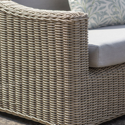 A view of a rattan armchair on a garden furniture lounge set