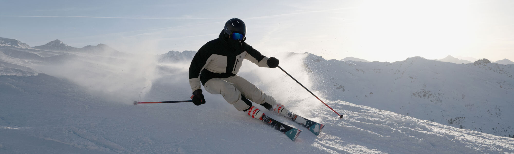 An image of a person skiing in a cream and black Dare 2b ski jacket
