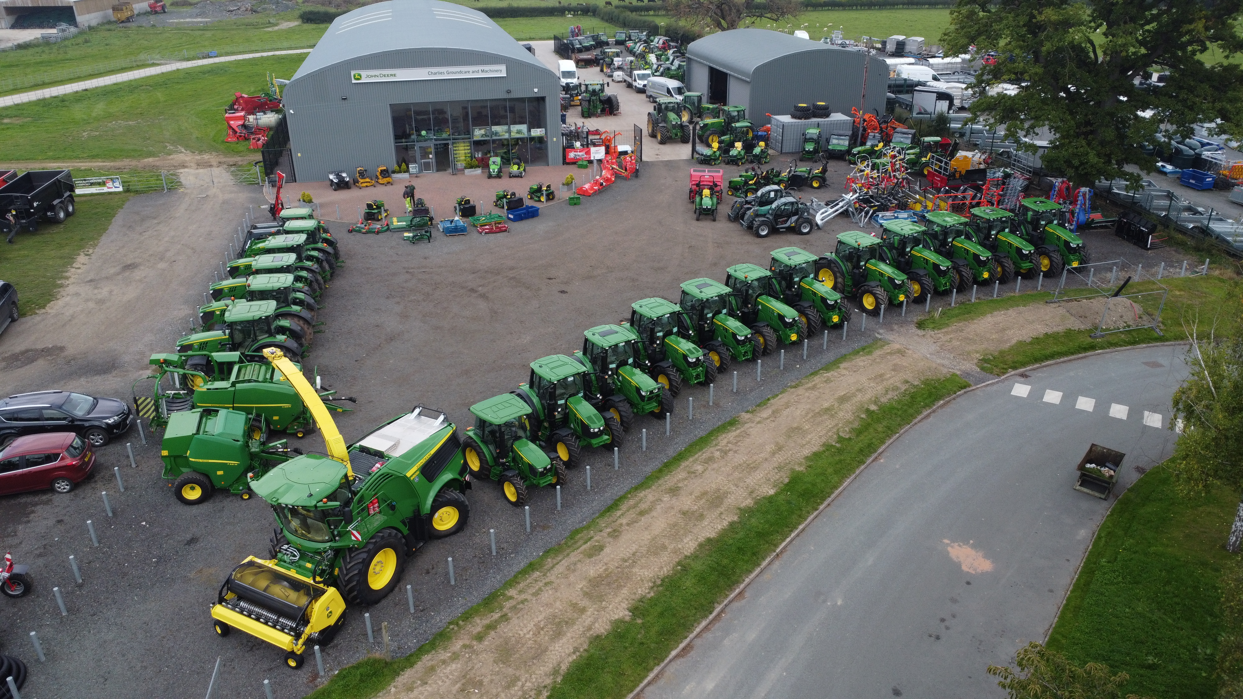 Aerial view of the Charlies Ag & Turf building with John Deer tractors and machinery  