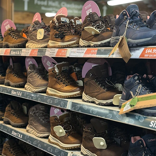 An image of shelves holding a range of walking boots.