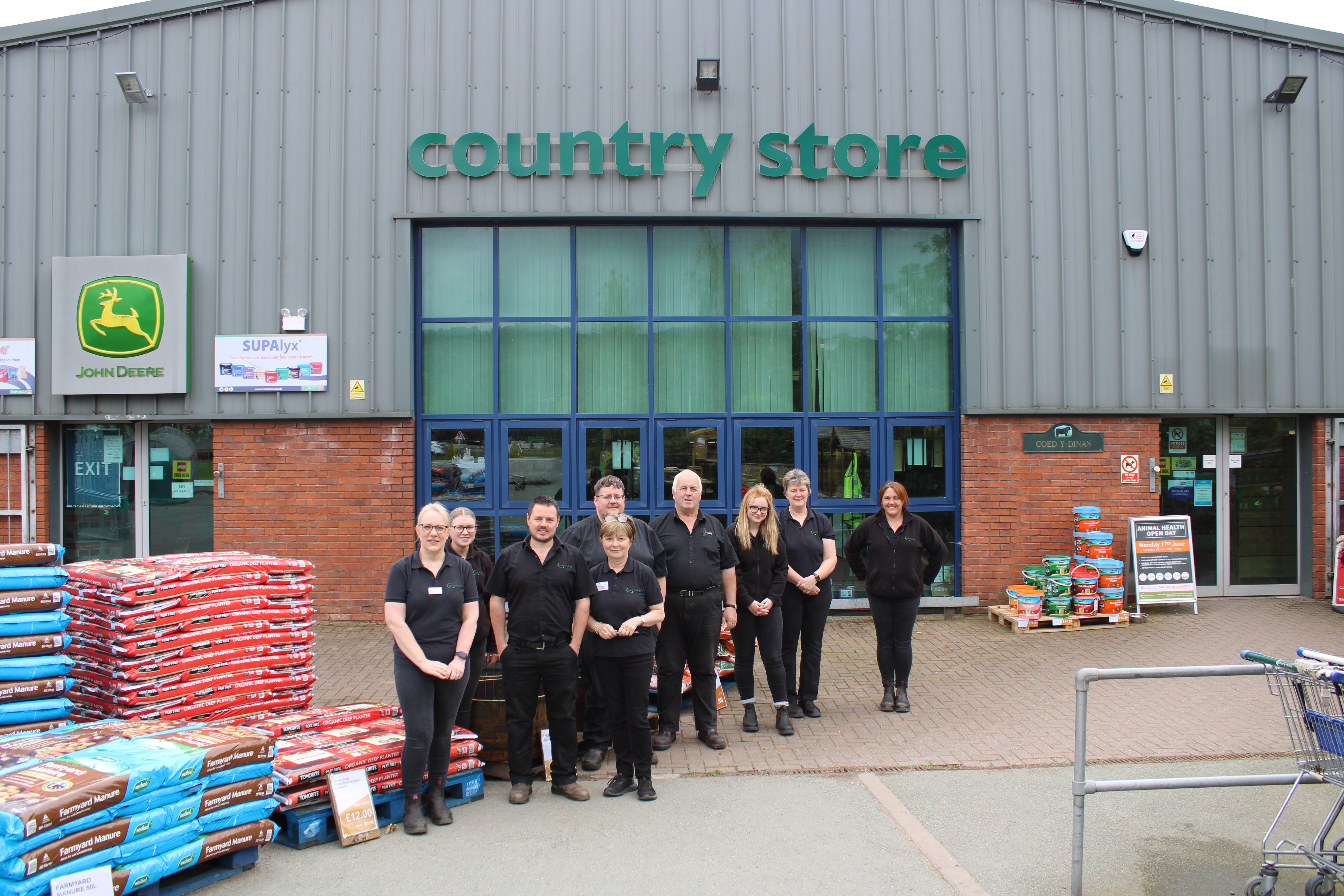 A view of a few members of the Country store team in Coed-Y-Dinas outside the store