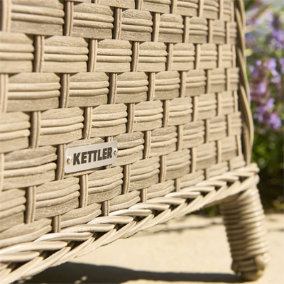 A close up view of a rattan garden furniture set with the kettler logo on it