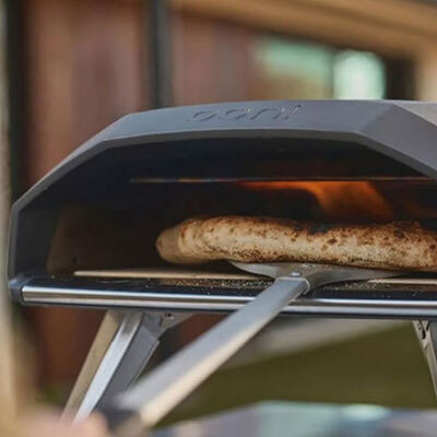 A close up of a pizza in an ooni pizza oven