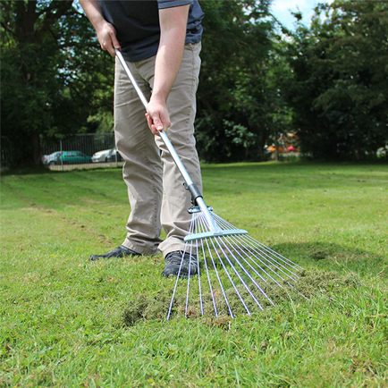 A view of a person using a Lawn Rake