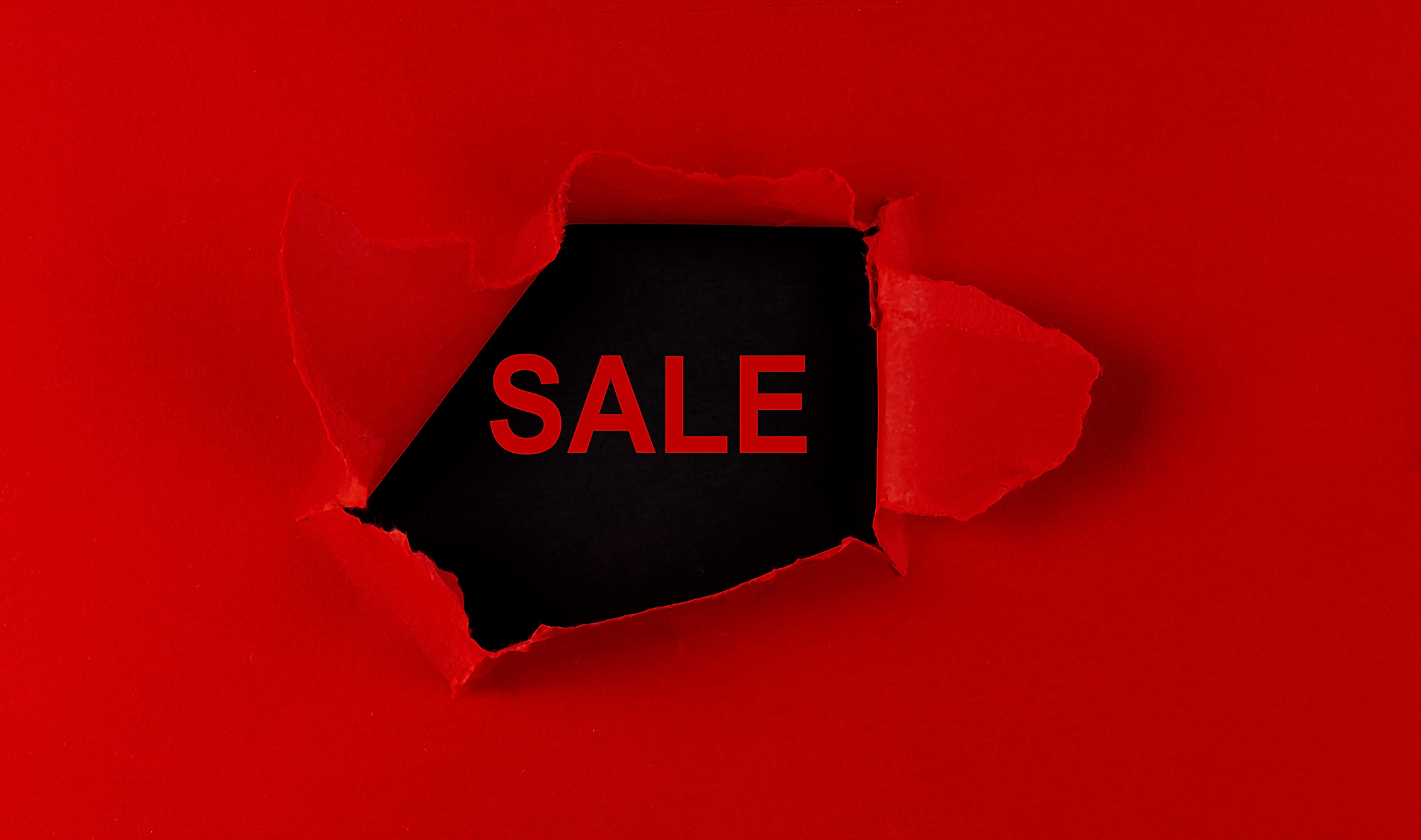 red-torn-paper-with-a-word-sale-on-the-black-background-231206116.jpeg